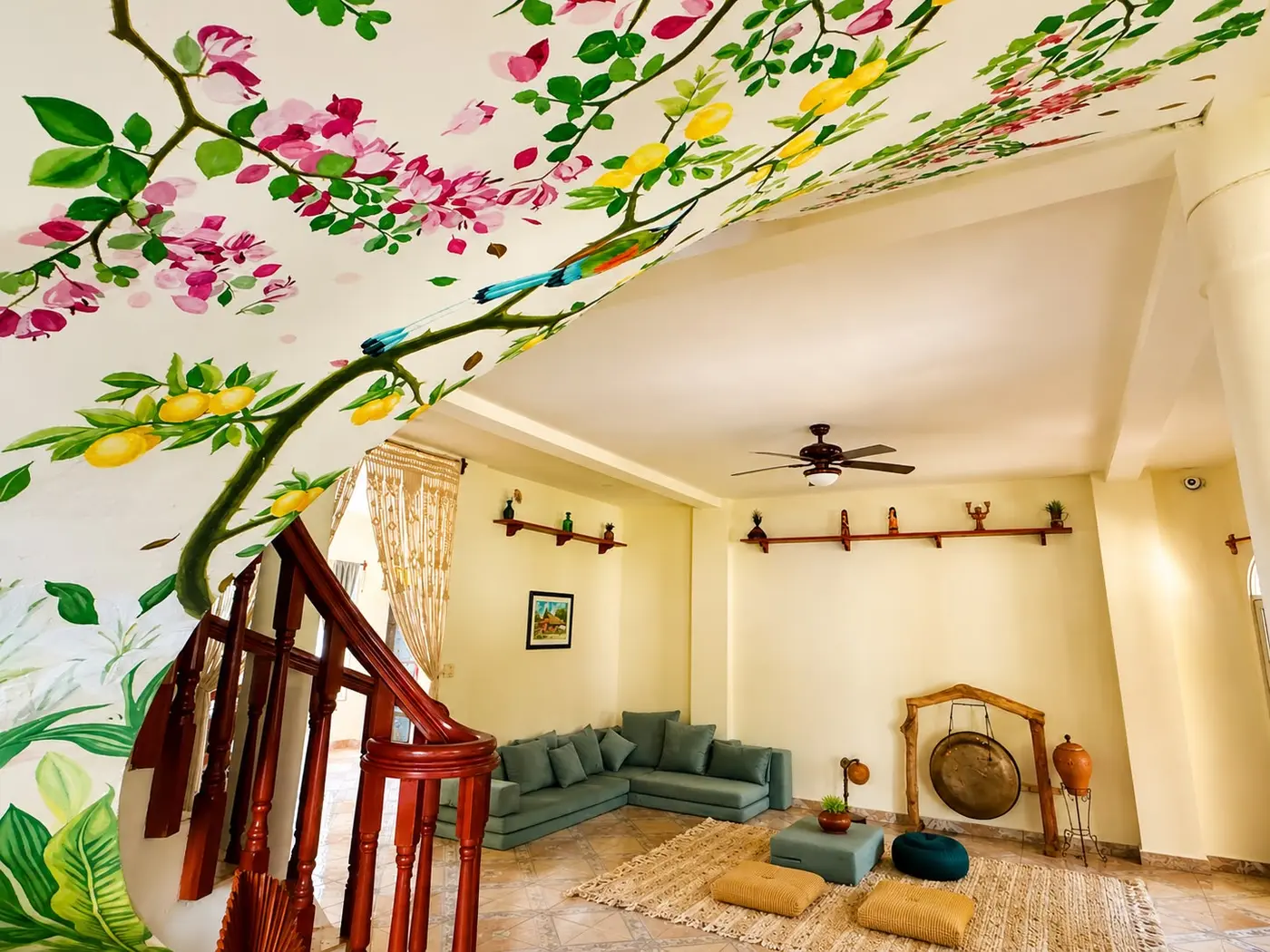 The indoor art and gathering sala with its hand-painted garden mural and sound gong